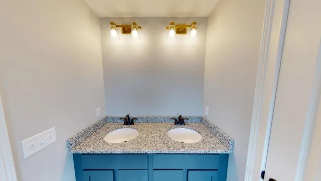 a bathroom with a granite countertop sink and mirror