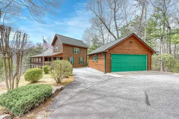 a front view of a house with a garden and plants