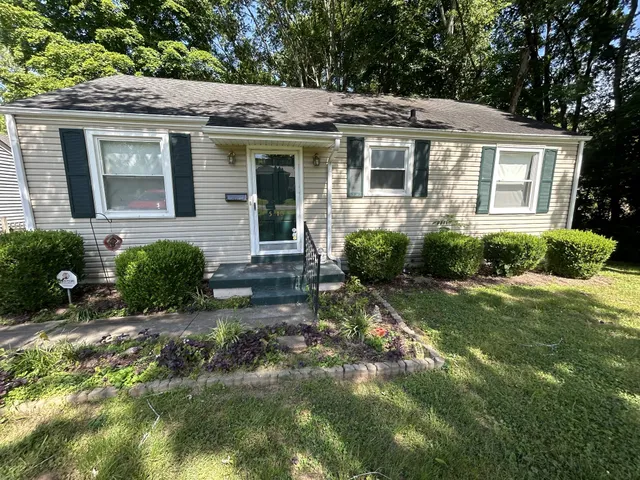 a view of a house with a yard and plants