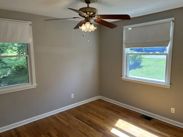 a view of room with window and hardwood floor