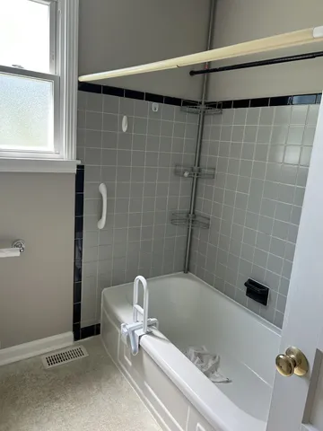 a bathroom with a bathtub and a shower