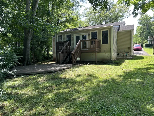 a view of a house with backyard and sitting area