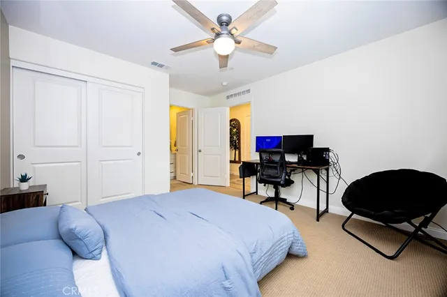 a bedroom with a bed and a chair