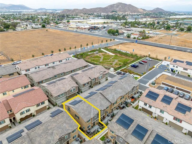 an aerial view of residential houses with outdoor space and river