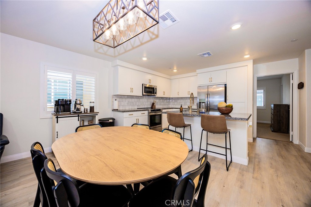 19245 Sequoia Grv Street Riverside, CA 92507 - Photo 5 of 25 a view of a dining room with furniture and wooden floor