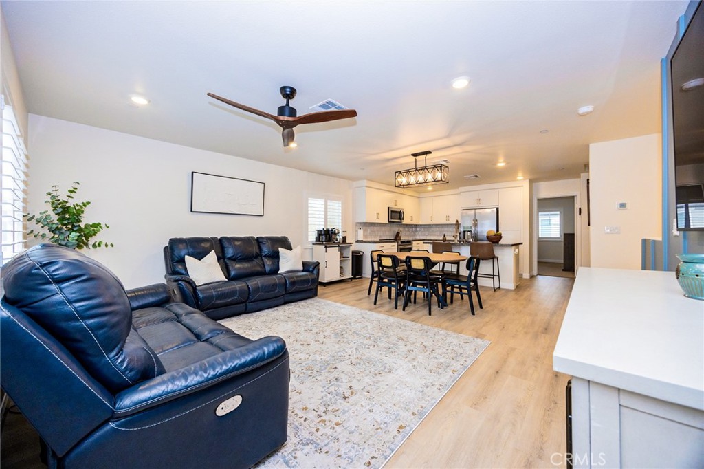 19245 Sequoia Grv Street Riverside, CA 92507 - Photo 7 of 25 a living room with furniture and a dining table with kitchen view