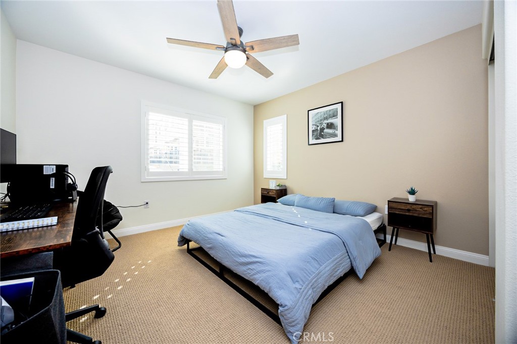 19245 Sequoia Grv Street Riverside, CA 92507 - Photo 10 of 25 a bedroom with a bed and a computer on the desk