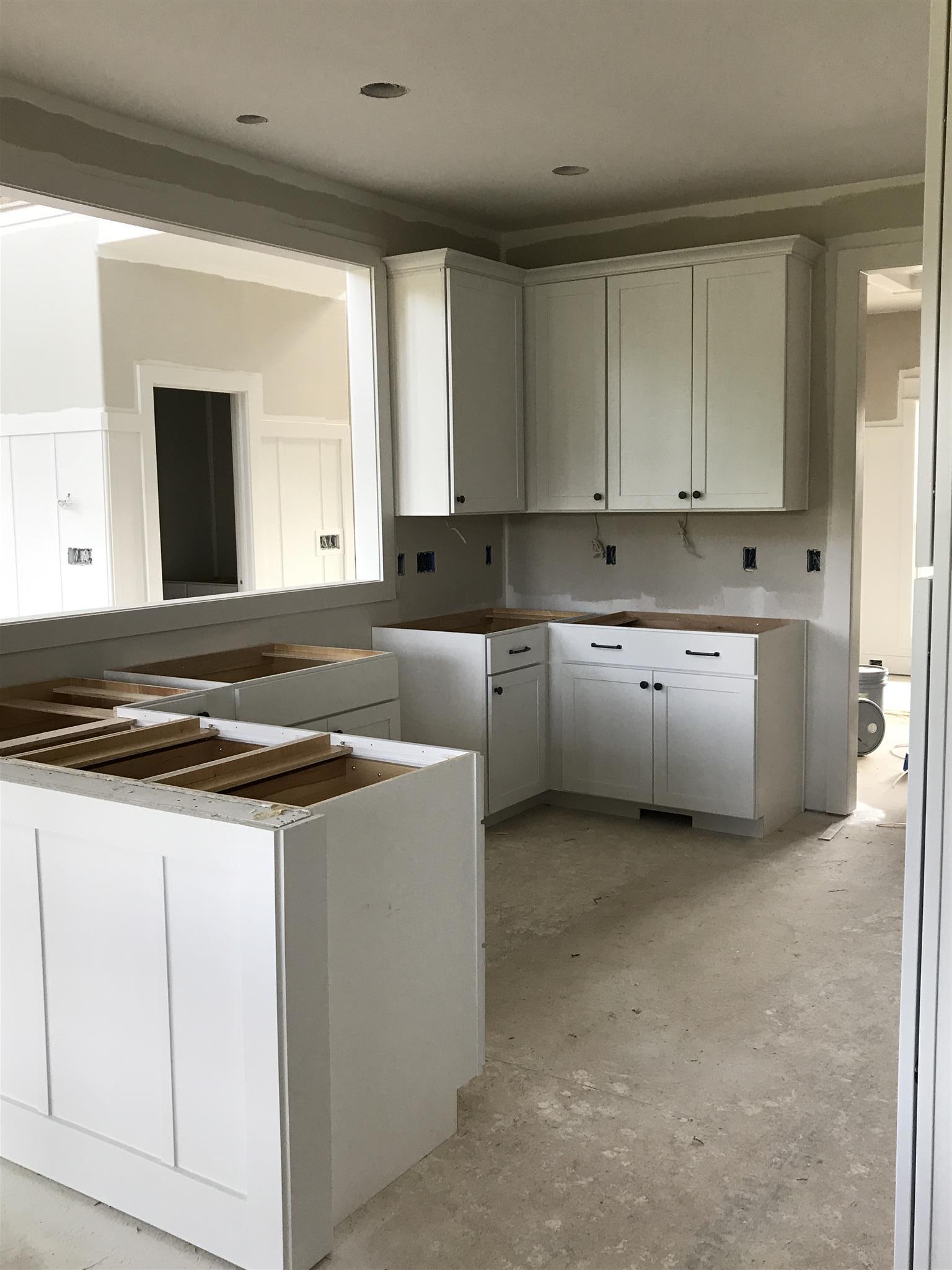 727 Philadelphia Road Lebanon, TN 37087 - Photo 9 of 16 a kitchen with granite countertop white cabinets and white appliances