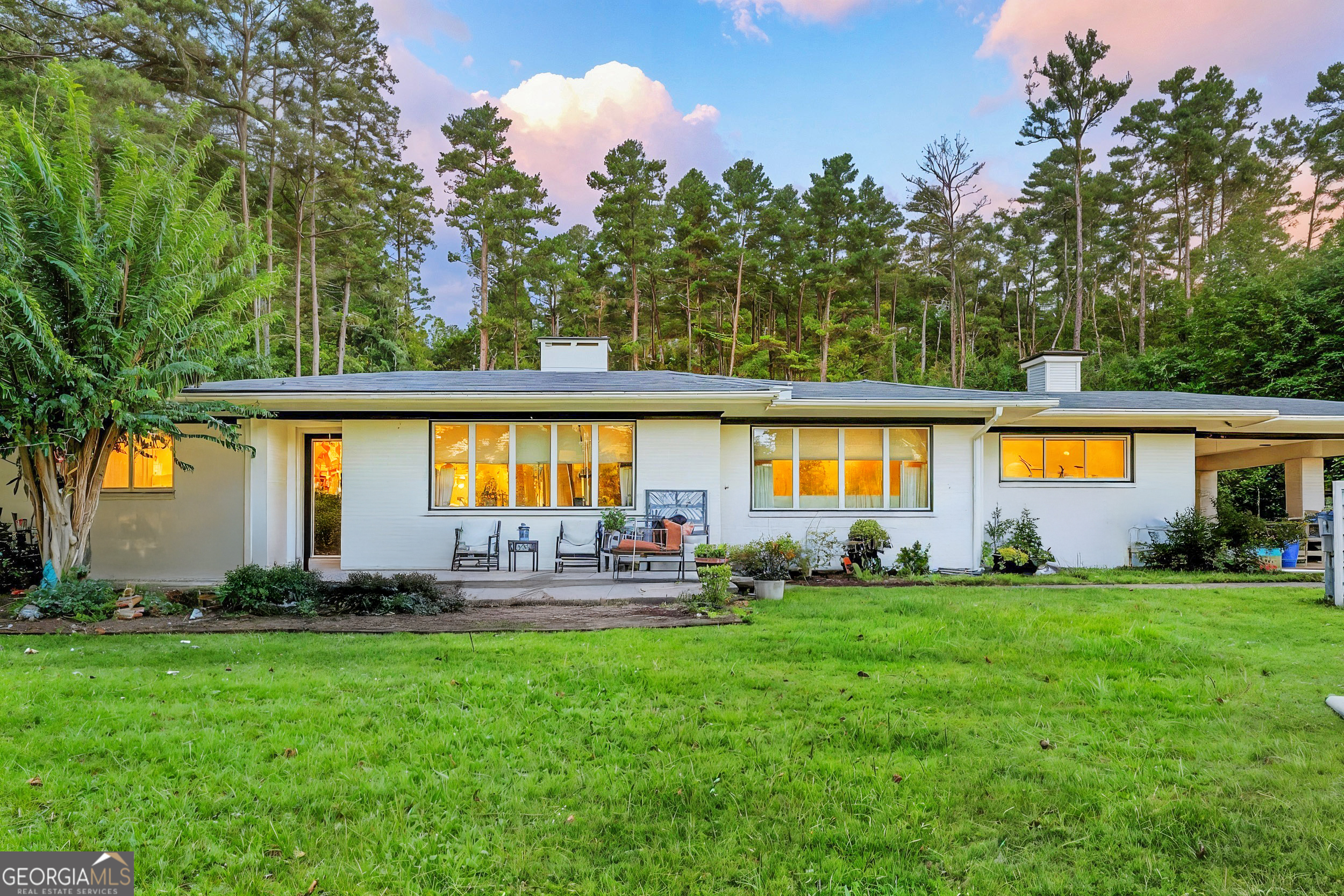 a front view of house with yard and outdoor seating
