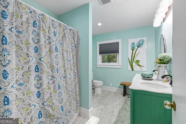 a view of a hallway with a livingroom and furniture