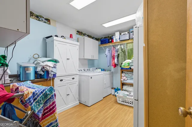 a work room with furniture and a flat screen tv