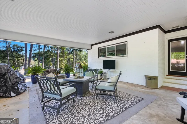 a view of a kitchen with a stove wooden floor and a chandelier