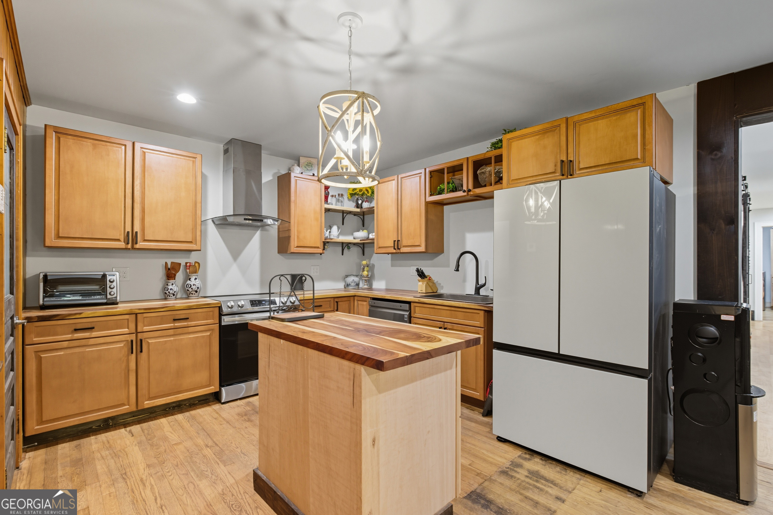 27 Rock Quarry Road Toccoa, GA 30577 - Photo 34 of 61 a kitchen with stainless steel appliances granite countertop a refrigerator a sink dishwasher a stove and a dining table with wooden floor