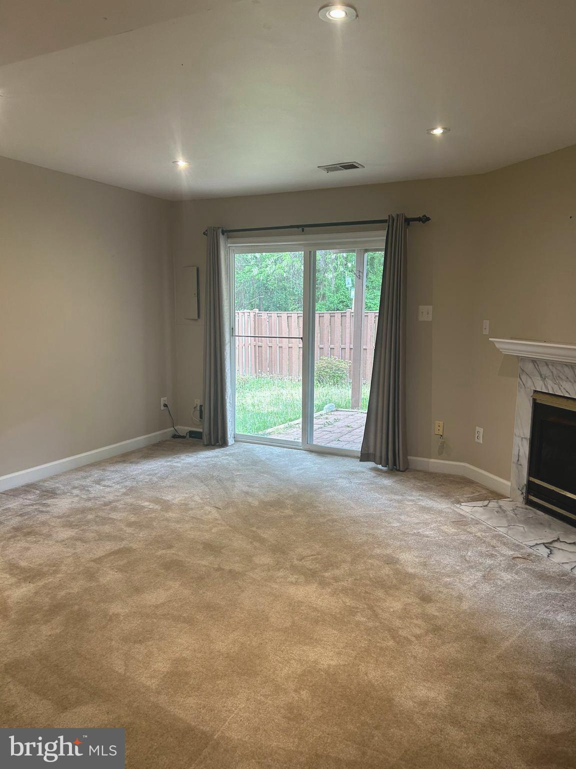 4658 Buckhorn Ridge Fairfax, VA 22030 - Photo 31 of 35 a view of an empty room with a fireplace and a window
