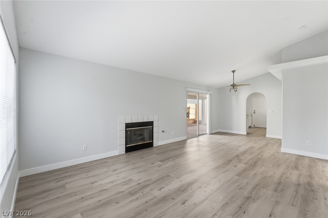 5449 Bugle Way, Unit 104 Las Vegas, NV 89108 - Photo 6 of 33 This bright living space features clean lines and a fireplace, offering comfort and style.