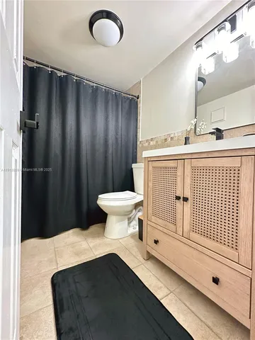 a bathroom with a sink toilet and a mirror