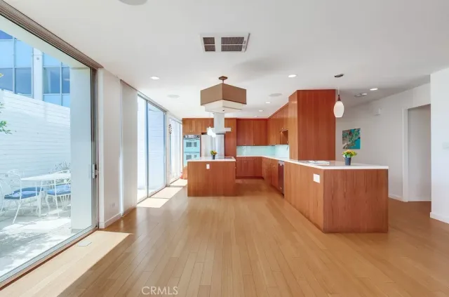 a kitchen with stainless steel appliances granite countertop a coffee maker a sink and a refrigerator