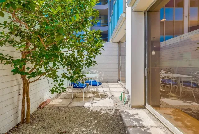 a balcony with table and chairs