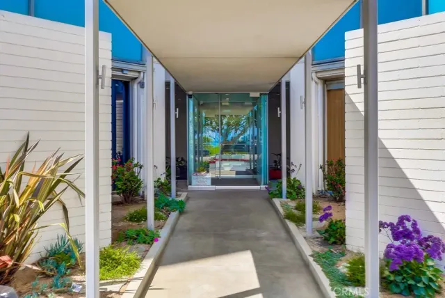 a view of a hallway with wooden floor and a workspace