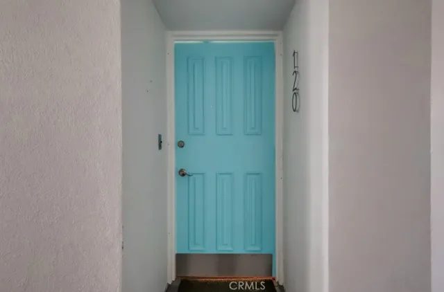 a view of a porch with furniture and a yard