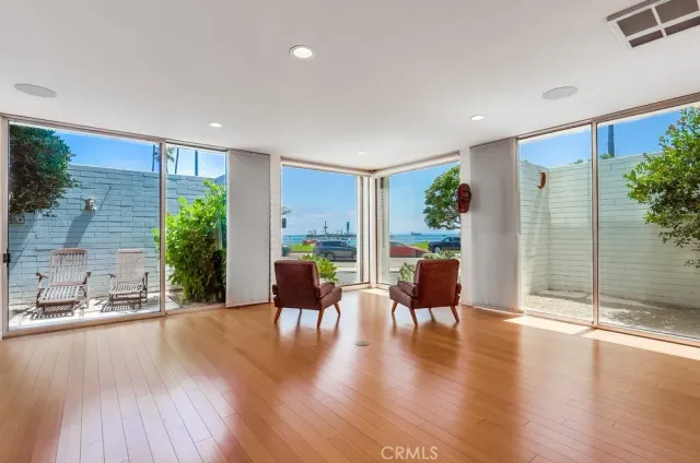 a large kitchen with stainless steel appliances granite countertop a large counter top a stove and a wooden floors