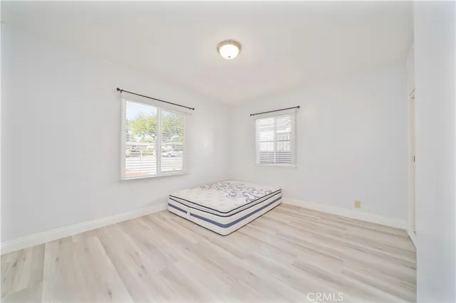 a view of room with window and wooden floor