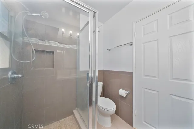 a bathroom with a granite countertop shower toilet and sink