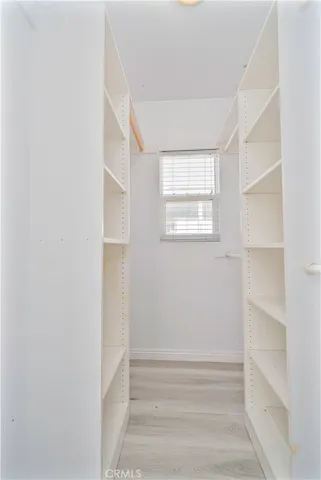a view of room with walk in closet and window