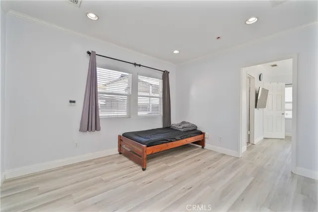 a living room with hard wood floors and a window