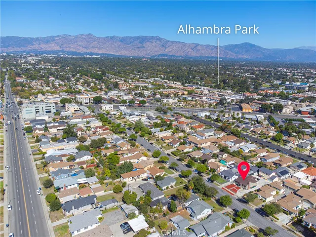 an aerial view of residential house with an outdoor space and seating