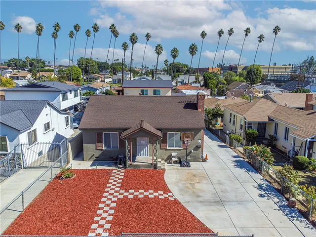 a view of a patio with couches table and chairs potted plants