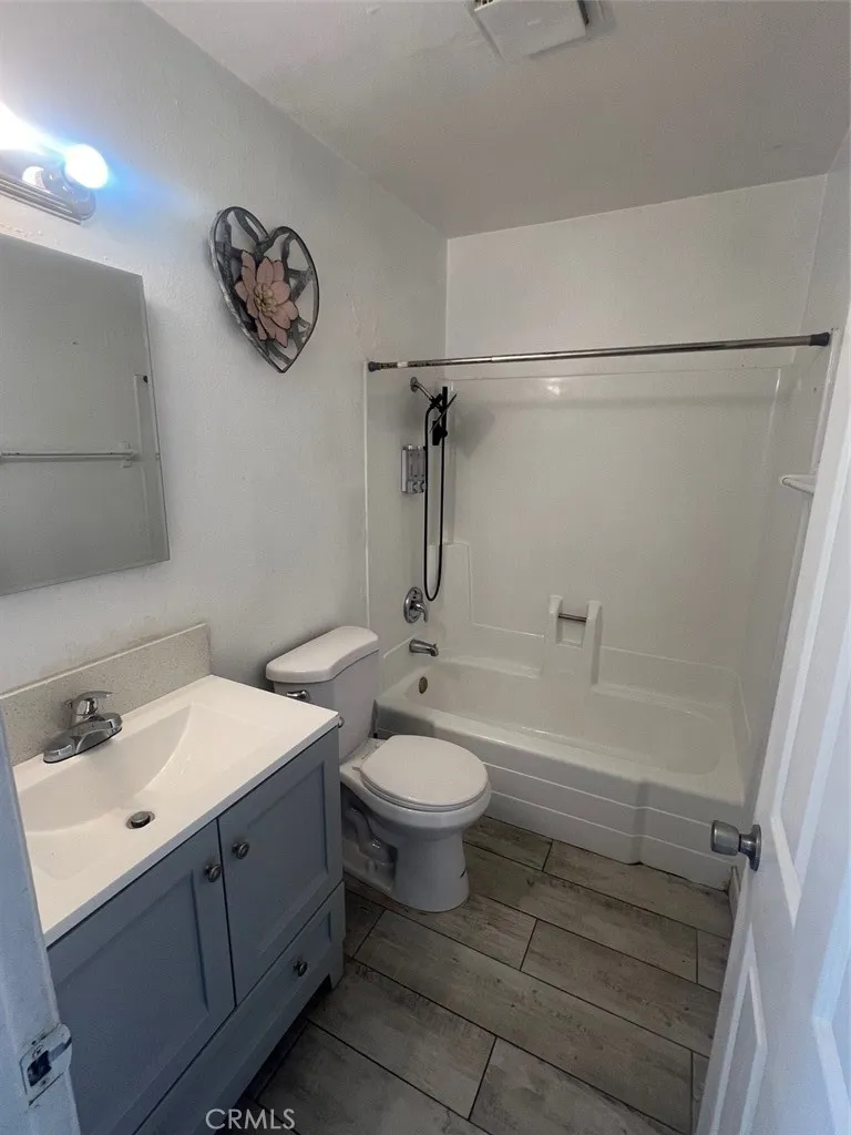 1064 West 48th Street San Bernardino, CA 92415 - Photo 6 of 12 a bathroom with a sink a toilet and shower