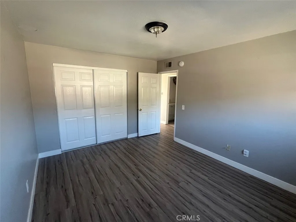 1064 West 48th Street San Bernardino, CA 92415 - Photo 10 of 12 a view of an empty room with wooden floor