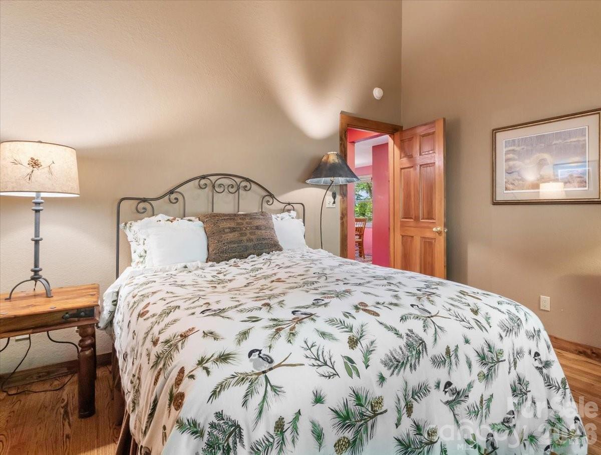 121 Ivy Ridge Road Burnsville, NC 28714 - Photo 29 of 48 a bedroom with a bed and a lamp on table