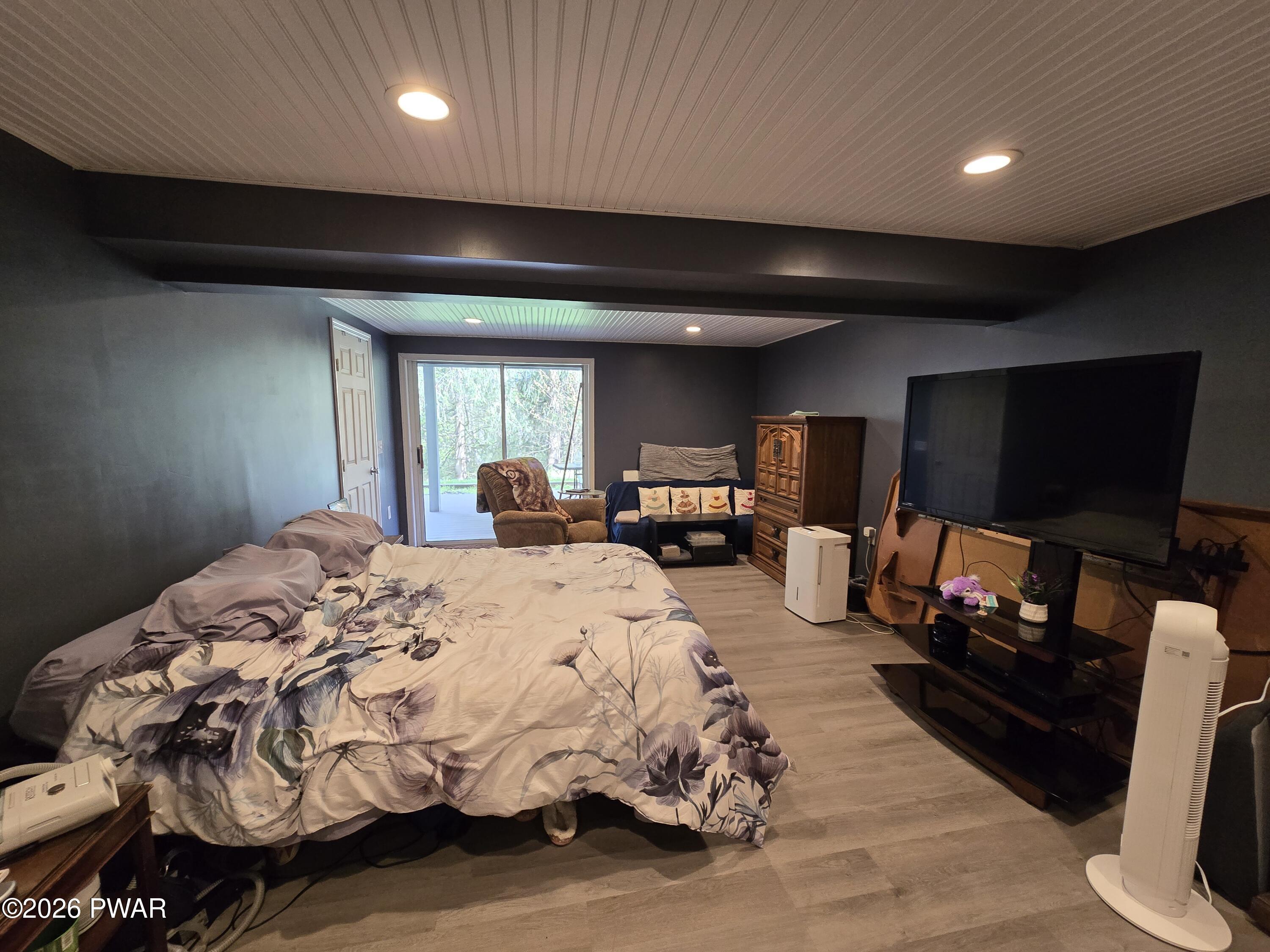 107 Keystone Hls Road, Unit 404 Factoryville, PA 18419 - Photo 11 of 23 a spacious bedroom with a bed and a flat screen tv