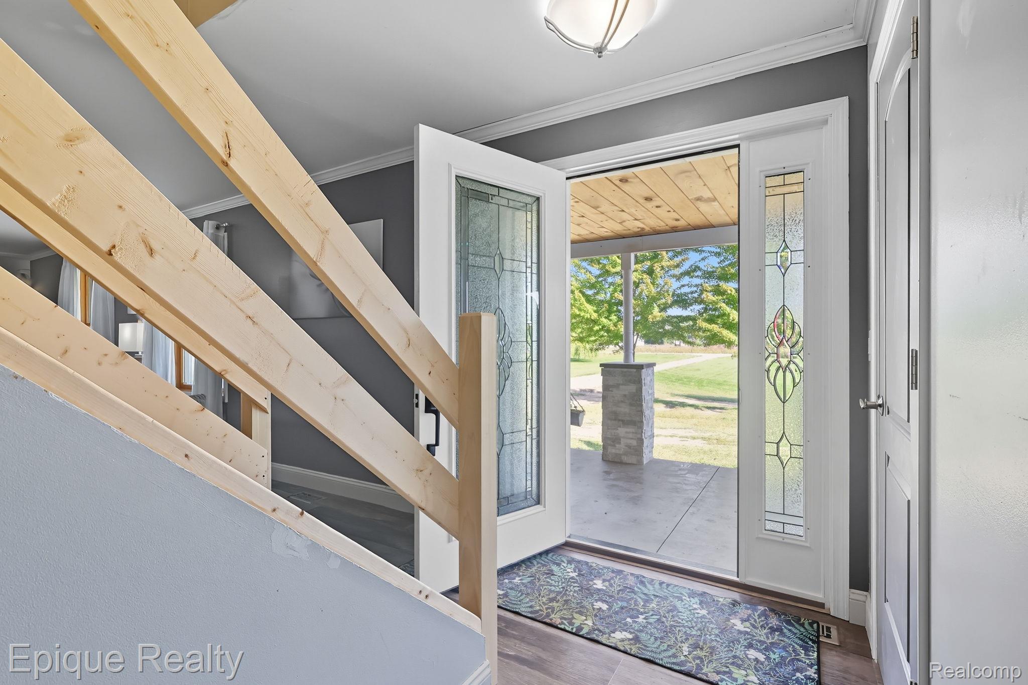 13265 Tibbets Road Memphis, MI 48041 - Photo 17 of 48 Foyer entrance featuring crown molding and wood finished floors