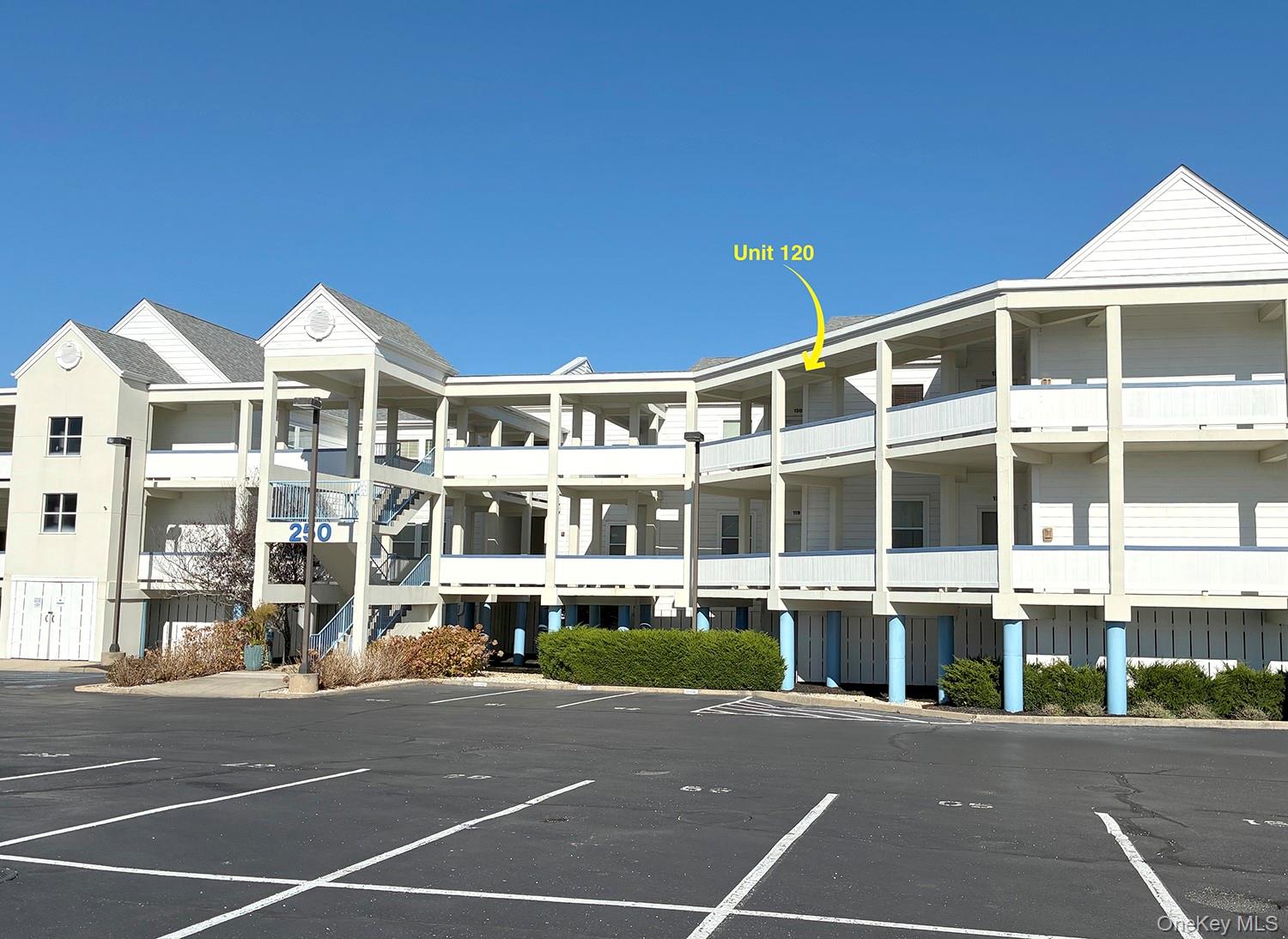 250 Dune Road, Unit 120 Westhampton Beach, NY 11978 - Photo 10 of 11 a front view of a building with a street