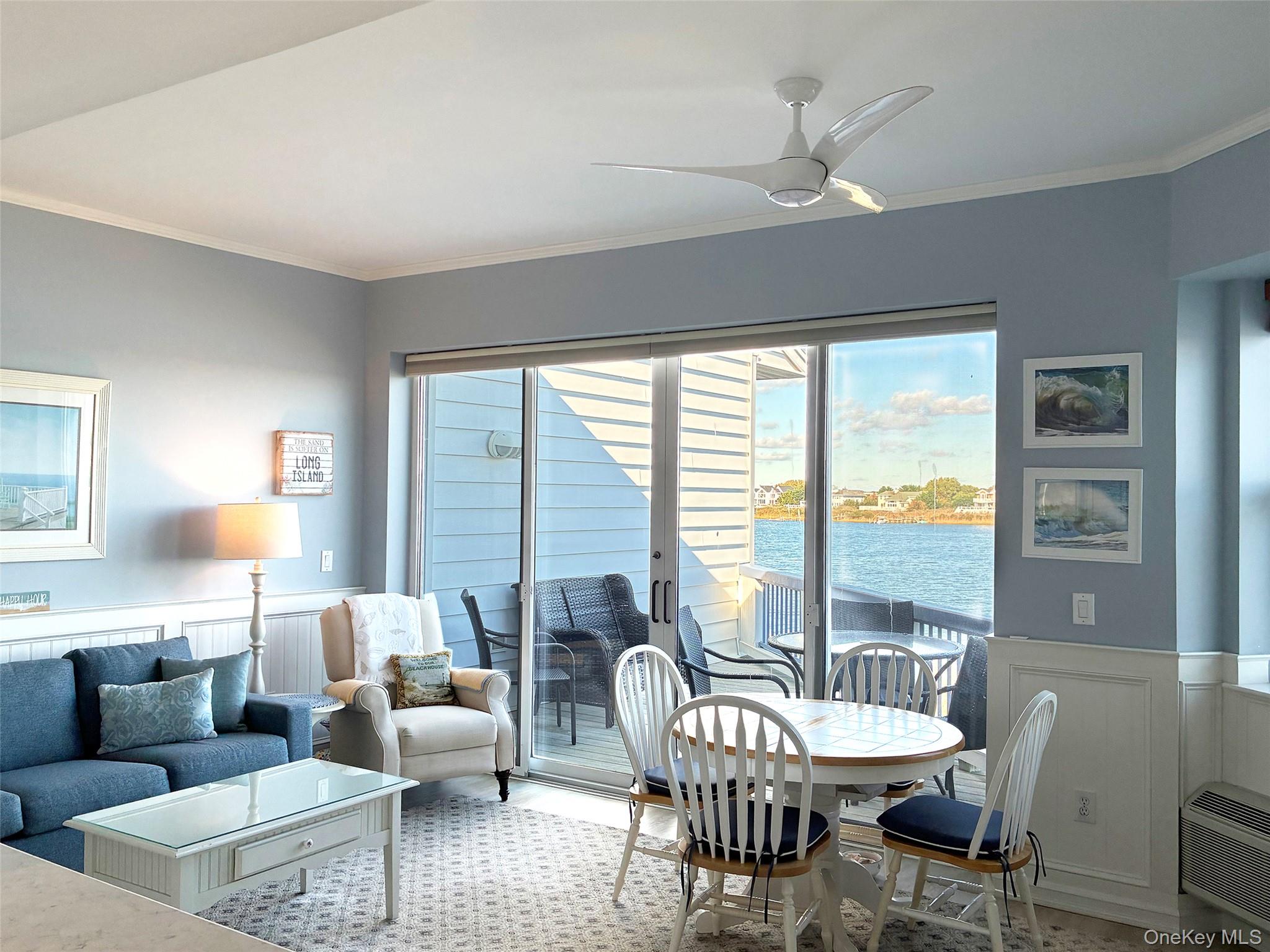 250 Dune Road, Unit 120 Westhampton Beach, NY 11978 - Photo 11 of 11 a living room with furniture and a large window