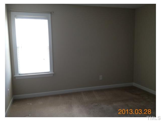4809 Landover Pine Place Raleigh, NC 27616 - Photo 8 of 11 a view of an empty room with wooden floor and a window