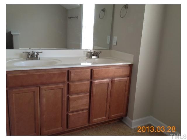 4809 Landover Pine Place Raleigh, NC 27616 - Photo 9 of 11 a bathroom with a sink and a mirror