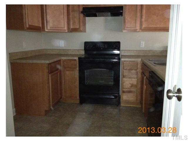 4809 Landover Pine Place Raleigh, NC 27616 - Photo 10 of 11 a kitchen with a stove and a cabinet