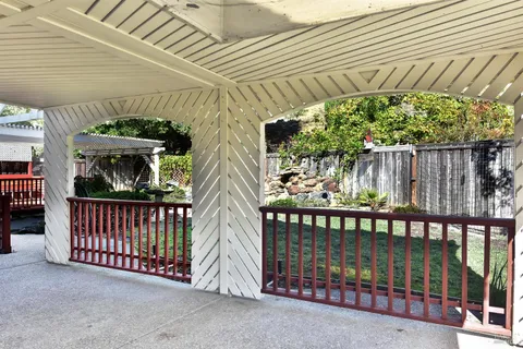 a view of a porch with wooden floor and fence