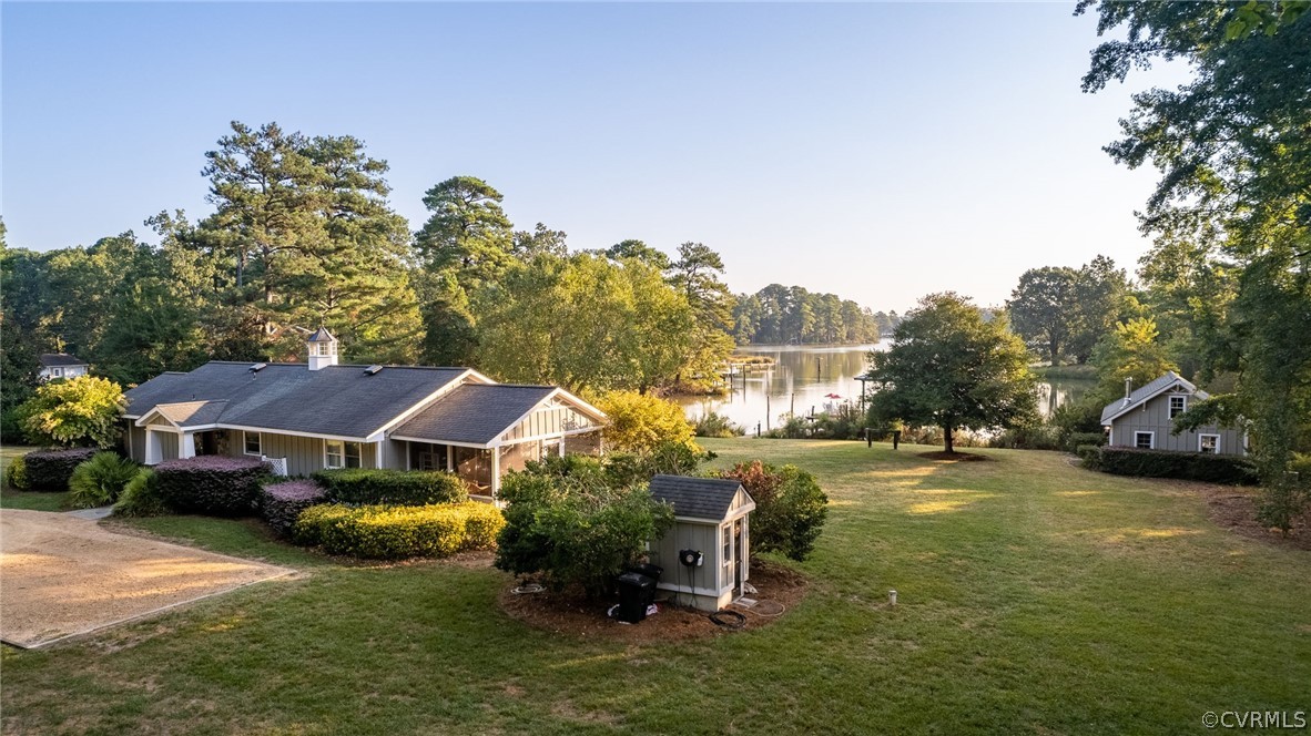 a aerial view of a house with swimming pool and next to a yard