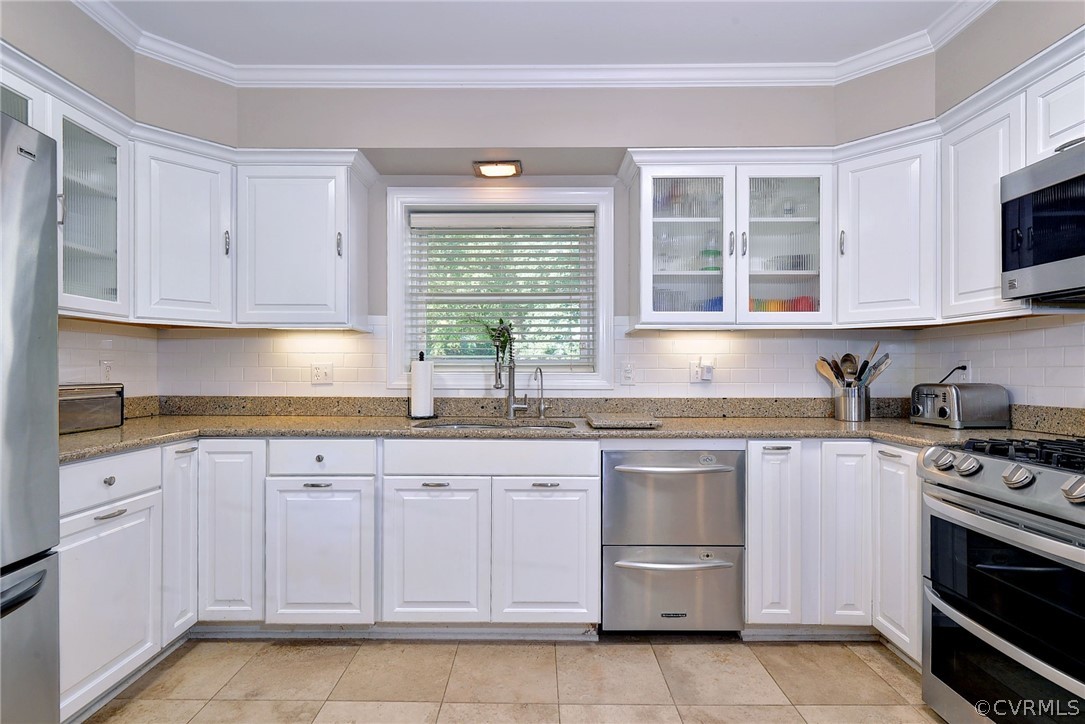 1020 Pine Hall Road Mathews, VA 23109 - Photo 11 of 49 a kitchen with granite countertop white cabinets stainless steel appliances and a sink