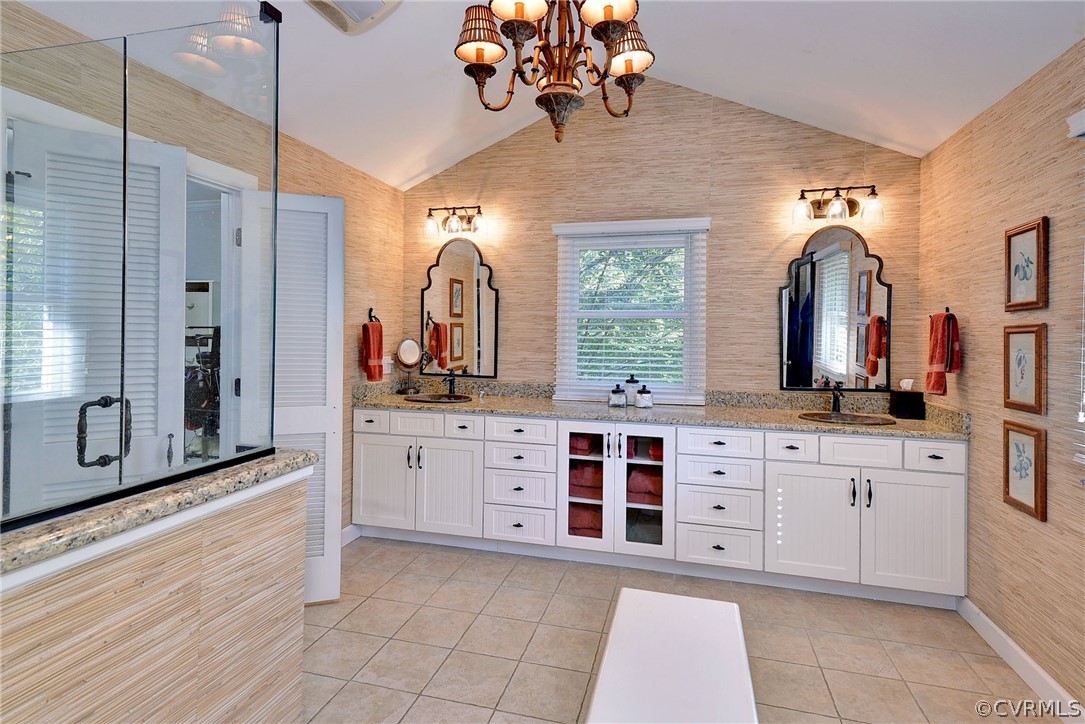 1020 Pine Hall Road Mathews, VA 23109 - Photo 15 of 49 a spacious bathroom with a double vanity sink a mirror a bathtub and a shower