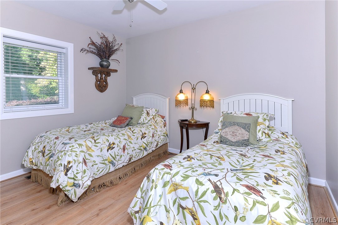1020 Pine Hall Road Mathews, VA 23109 - Photo 18 of 49 a bedroom with two beds and a chandelier