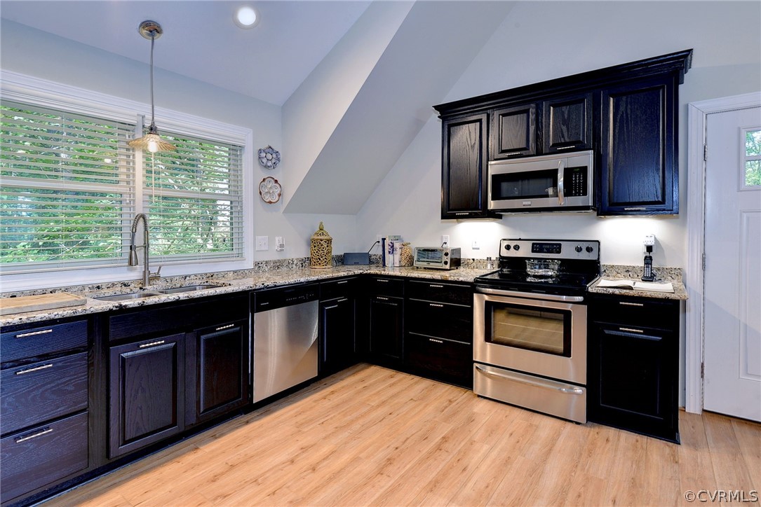 1020 Pine Hall Road Mathews, VA 23109 - Photo 32 of 49 a kitchen with stainless steel appliances granite countertop a stove a sink and a microwave