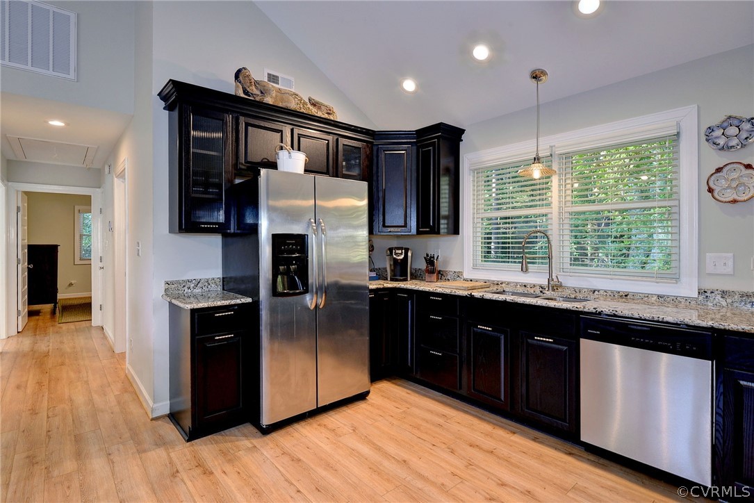 1020 Pine Hall Road Mathews, VA 23109 - Photo 33 of 49 a kitchen with stainless steel appliances granite countertop a refrigerator a sink a stove and wooden floors