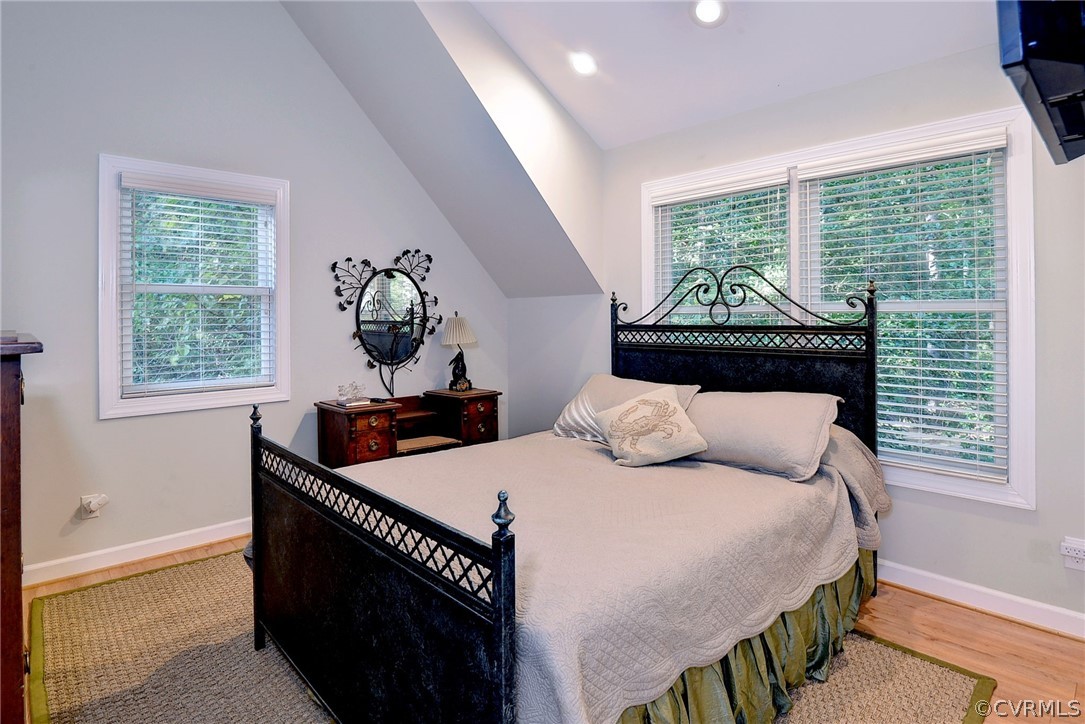 1020 Pine Hall Road Mathews, VA 23109 - Photo 34 of 49 a bedroom with a bed a dresser next to a window