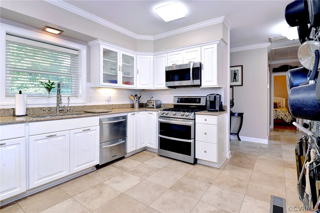 1020 Pine Hall Road Mathews, VA 23109 - Photo 10 of 49 a kitchen with stainless steel appliances granite countertop a stove top oven a sink dishwasher and white cabinets with wooden floor